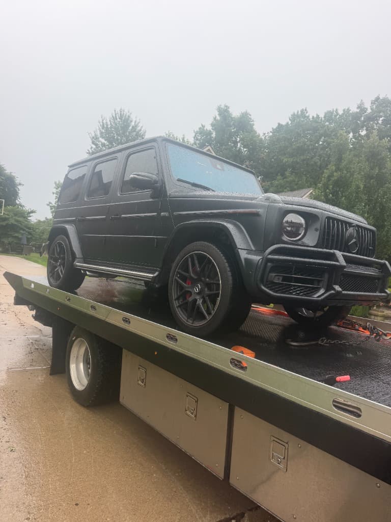 Black Mercedes-Benz G-Wagon secured on a Ritchie Express Towing flatbed